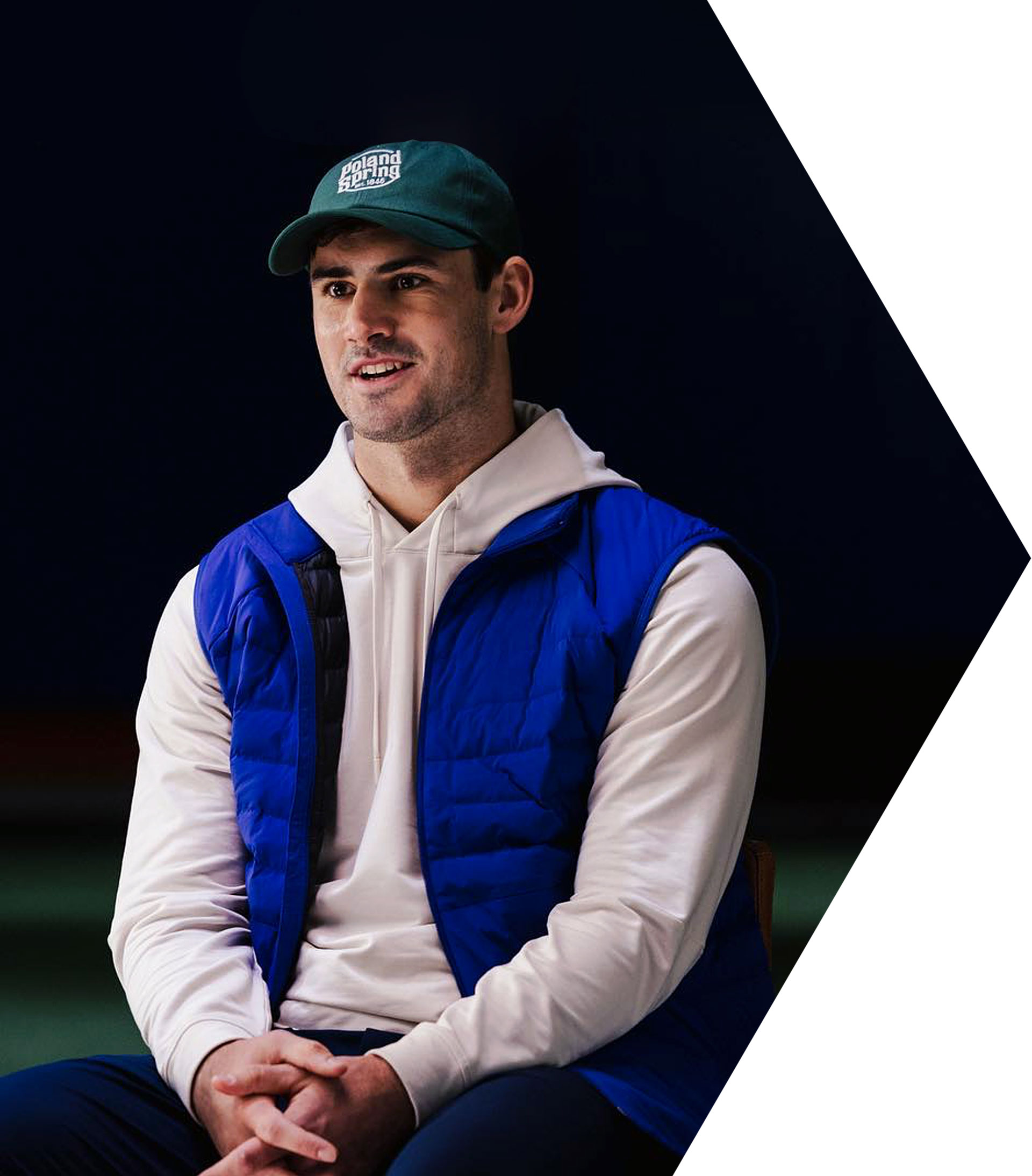 Daniel Jones speaks on stage about leadership and resilience as a motivational speaker.